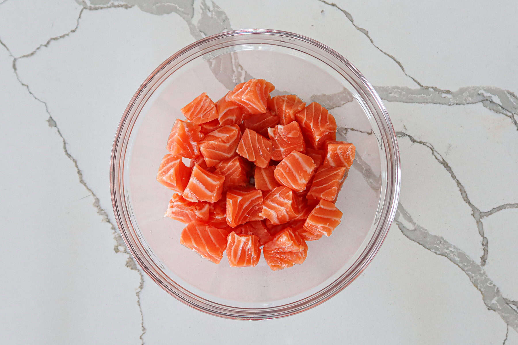 Salmon cubes in a large mixing bowl.