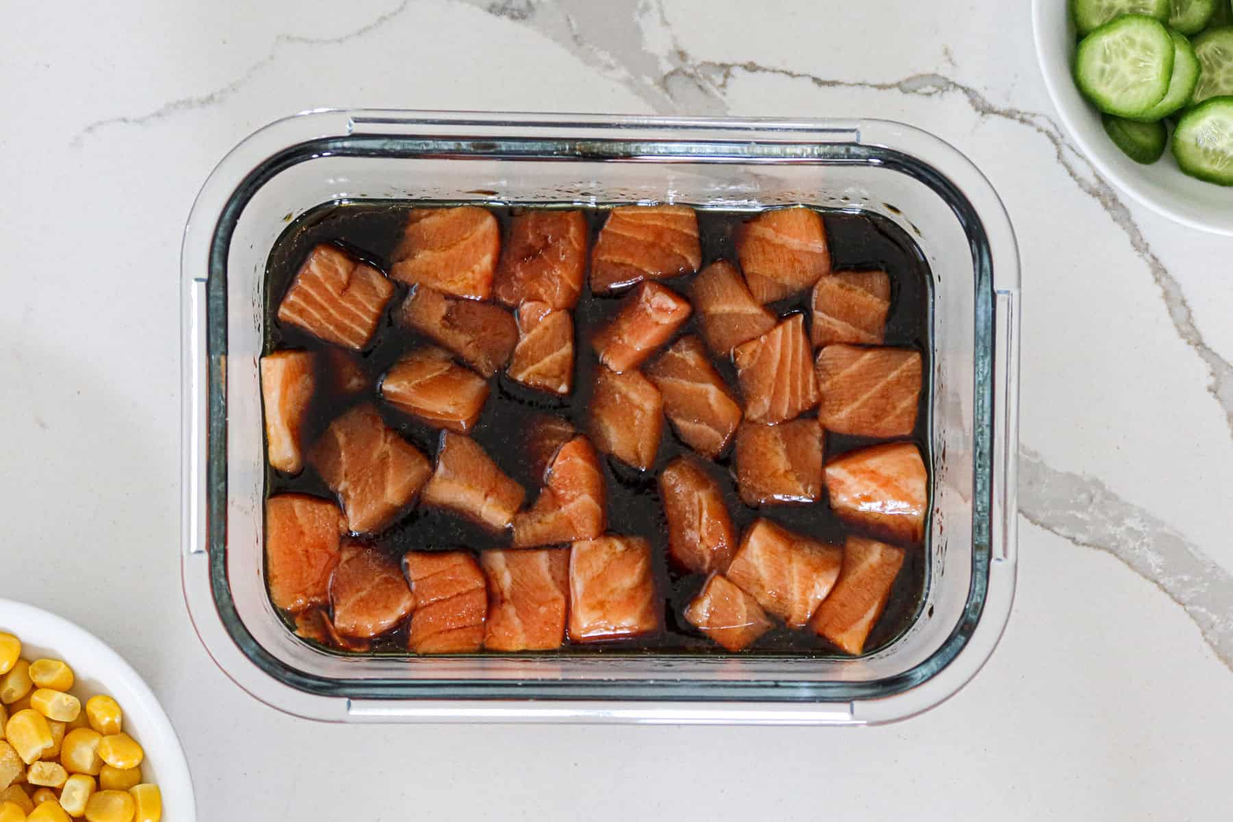 Raw salmon cubes in marinade.