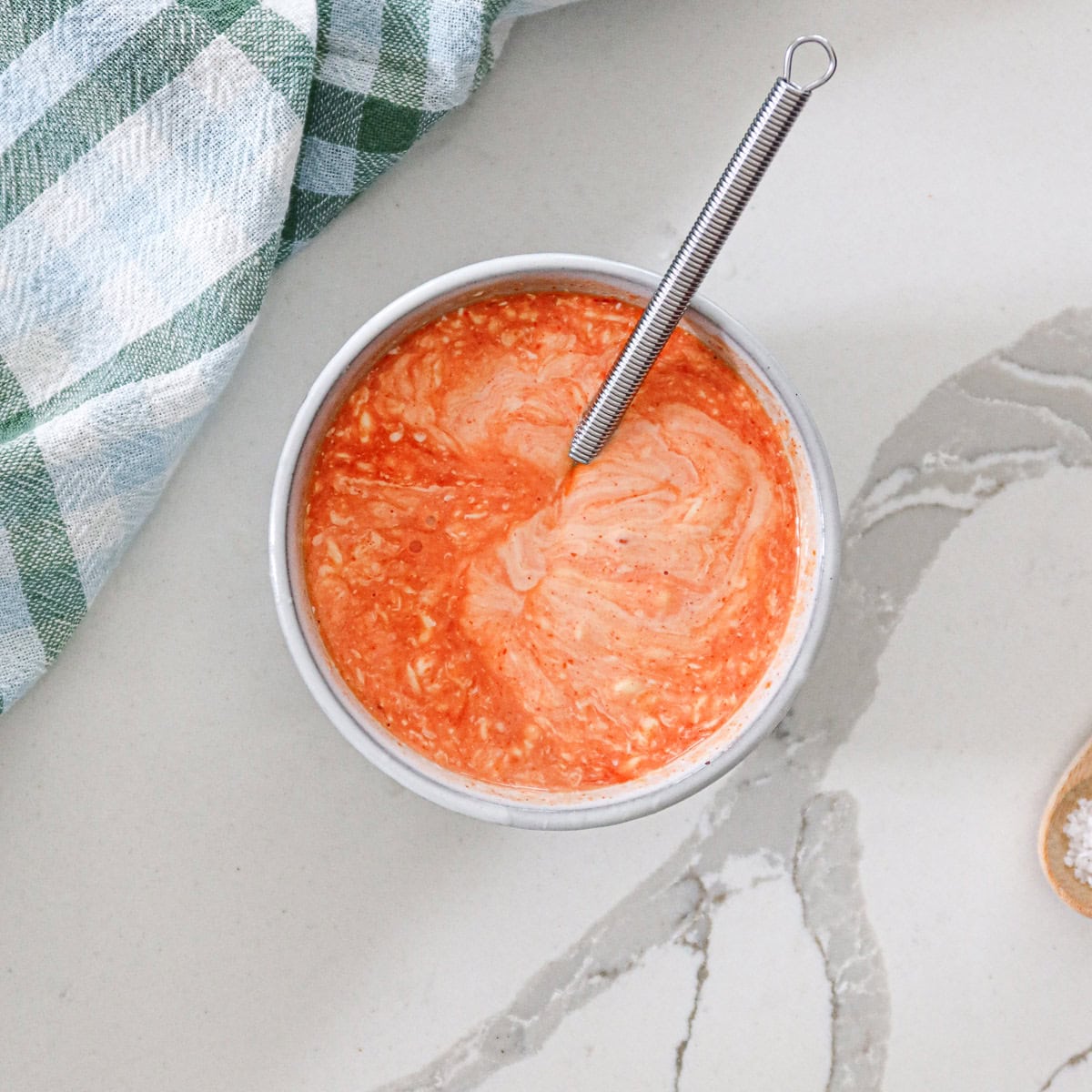 Mixing mayo, sriracha, lime juice and salt together in a small mixing bowl.