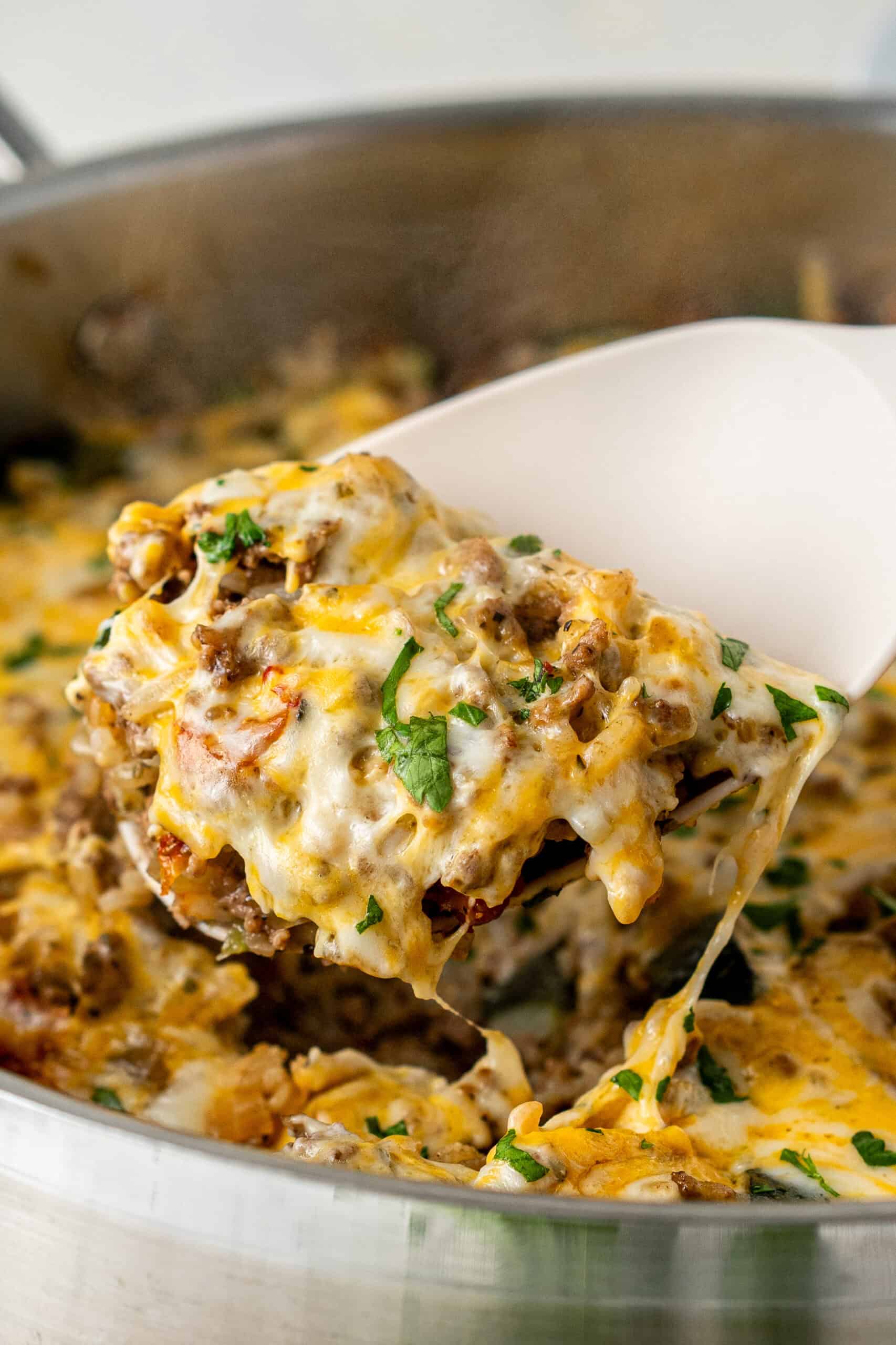 Close up spoonful of zucchini ground beef and rice casserole.