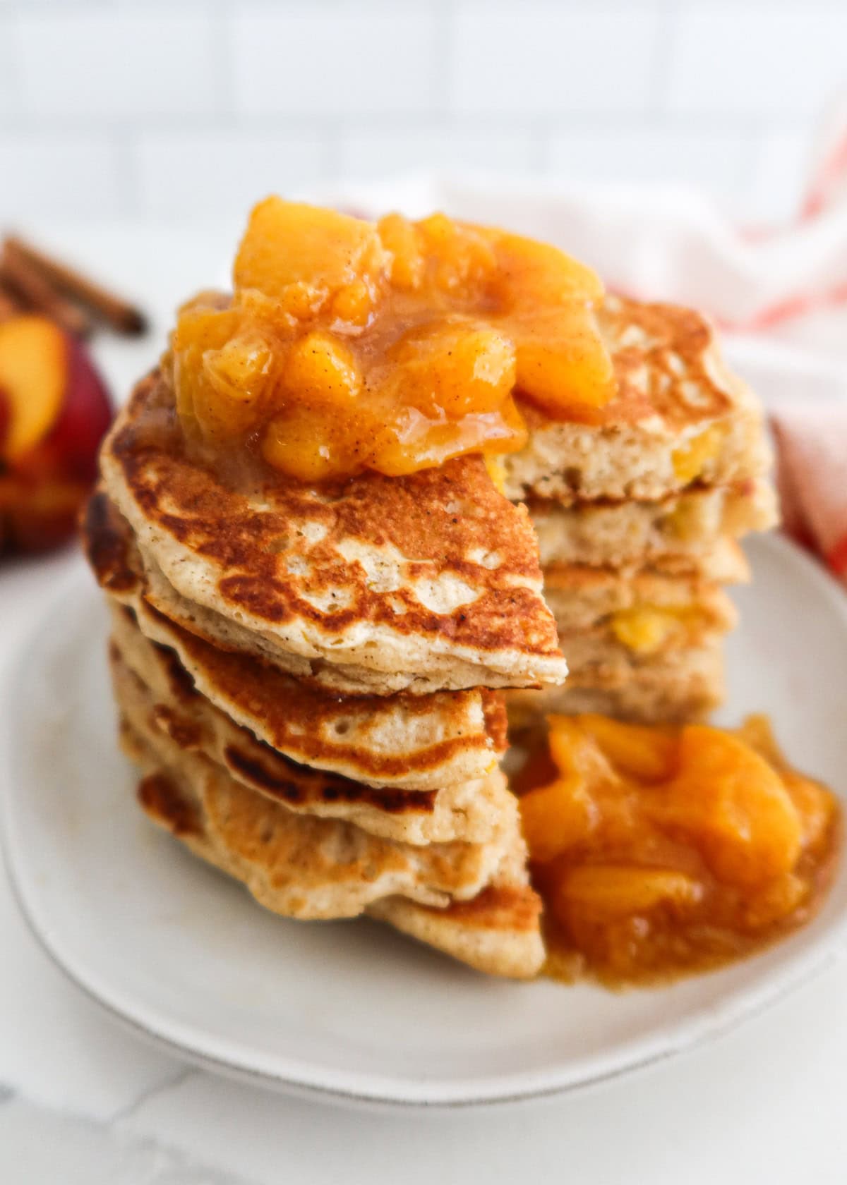 Peach compote spooned on top of pancakes.