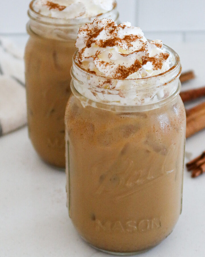 Homemade iced pumpkin spice lattes in mason jars.
