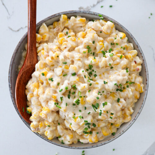 Creamed corn with cream cheese in a serving bowl.