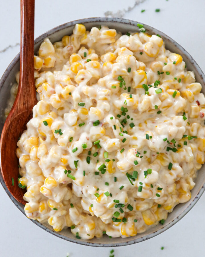 Creamed corn with cream cheese in a serving bowl.