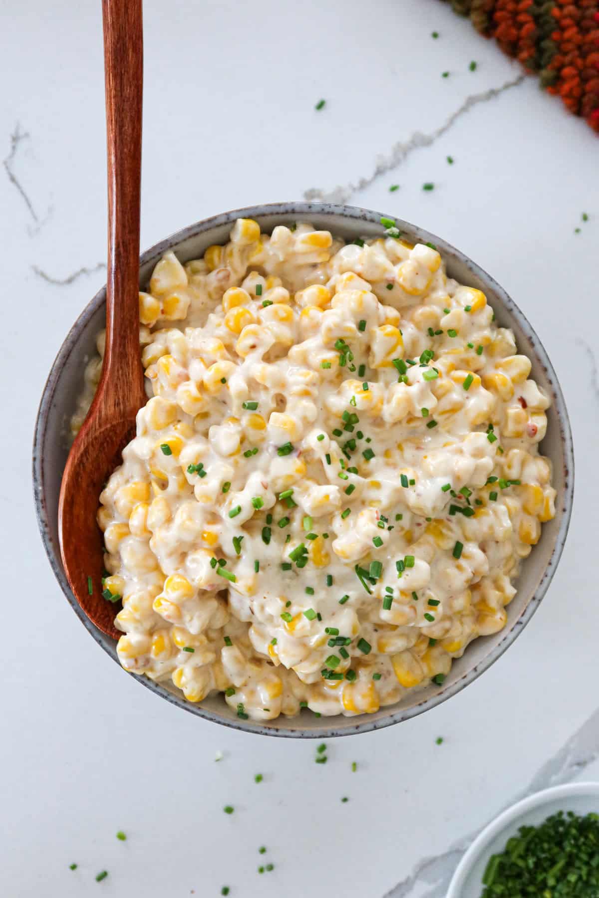 Creamed corn with cream cheese in a serving bowl.