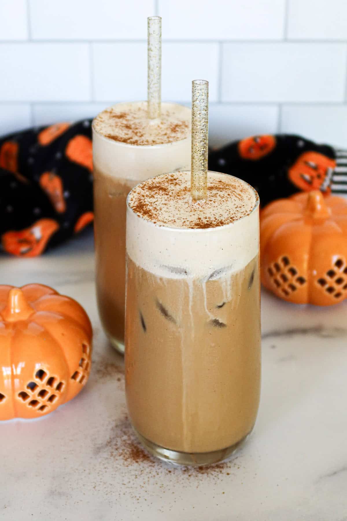 Two pumpkin cream cold brews in drinking glasses.