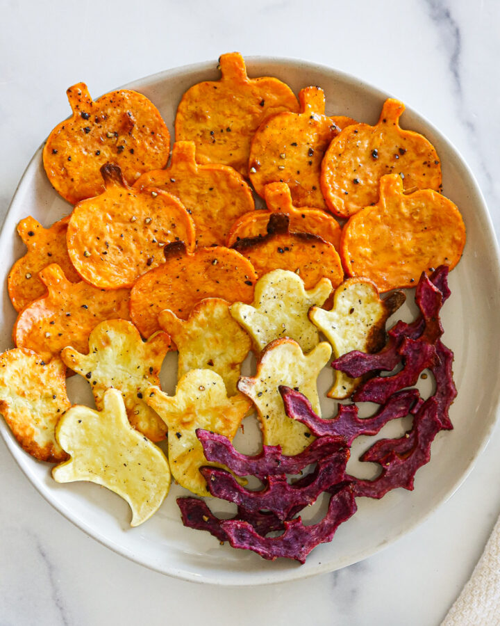 Spooky roasted sweet potatoes on a white plate.