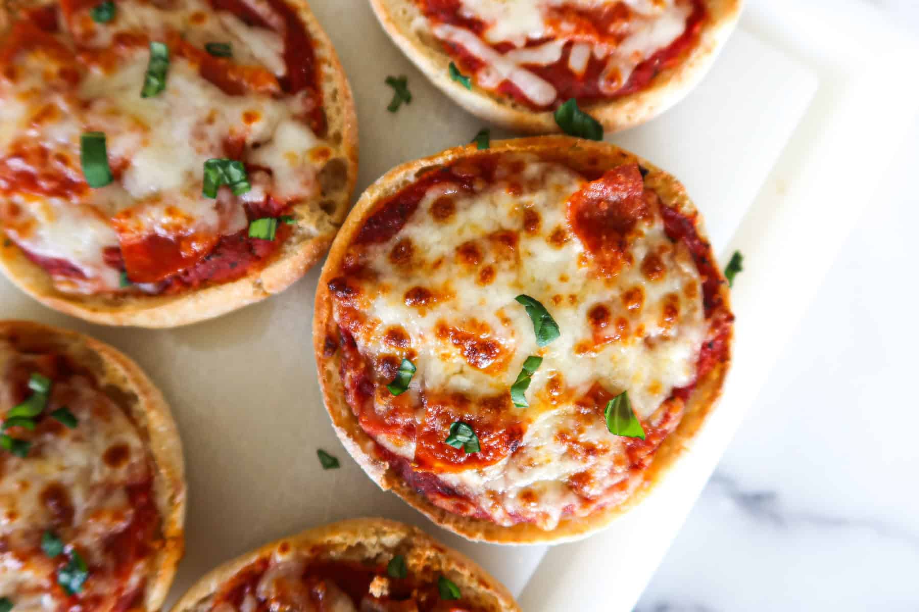 English muffin pizzas close up.