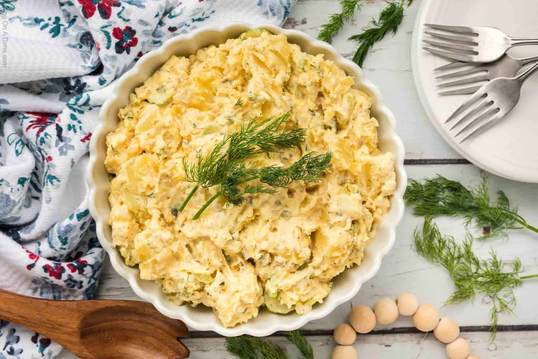 Potato salad in a white serving bowl.