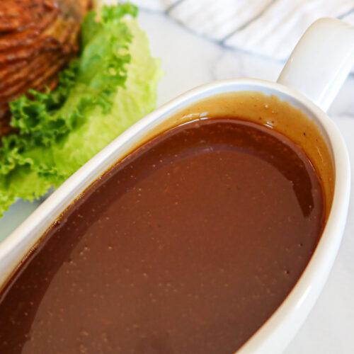 Ham gravy in a white gravy boat.