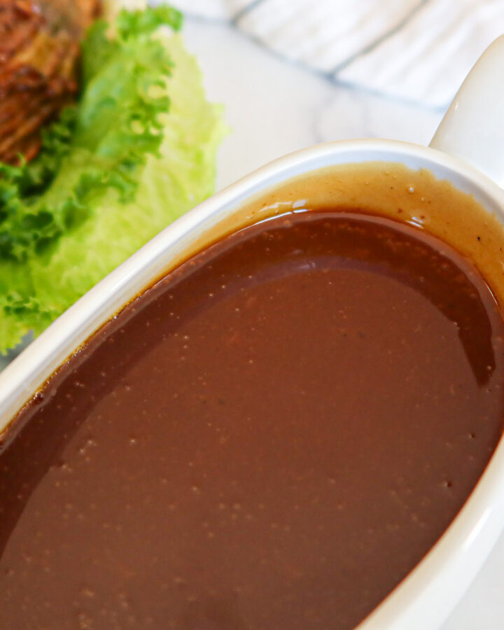 Ham gravy in a white gravy boat.