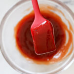 Close up of meatloaf glaze on a silicone brush.