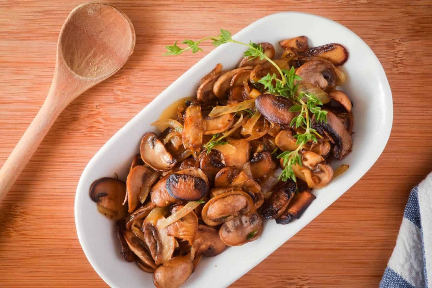 Sautéed mushrooms on a white serving plate.
