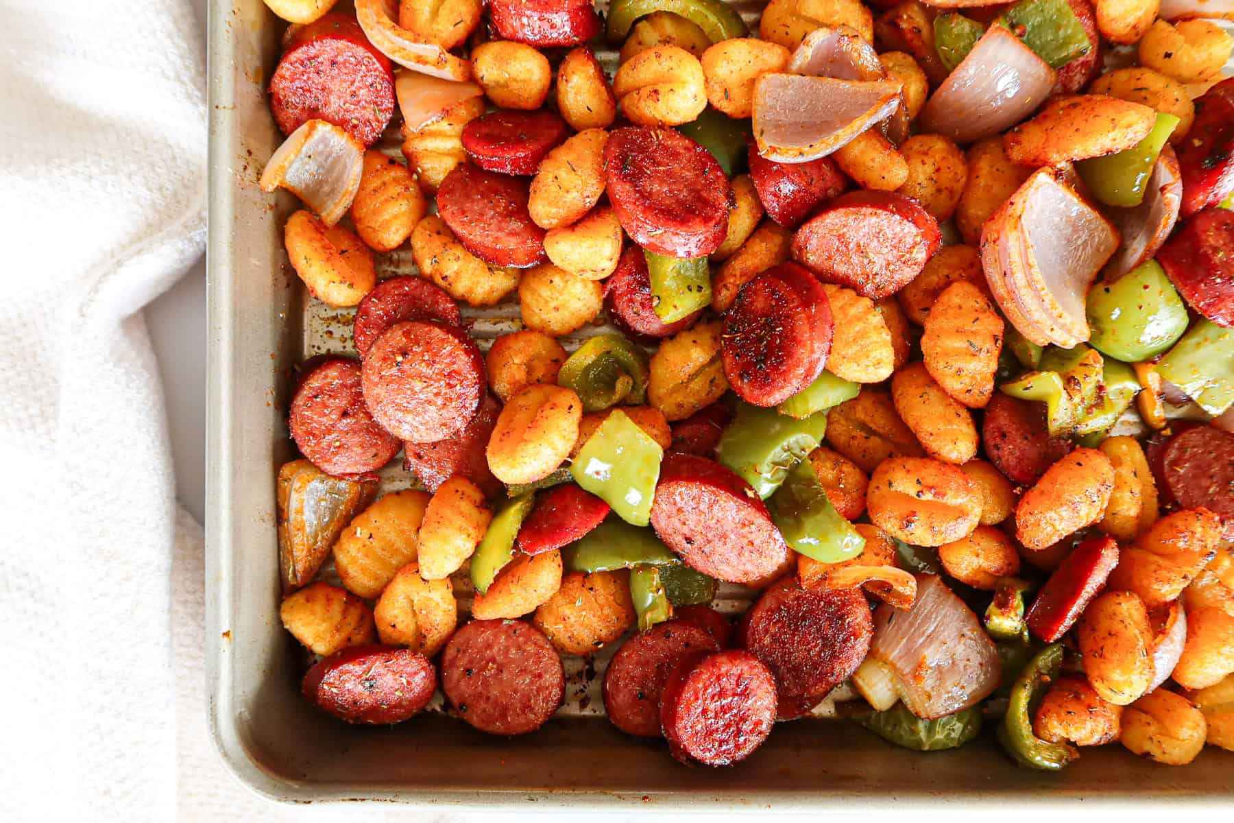 Roasted sausage, veggies and gnocchi on a sheet pan.