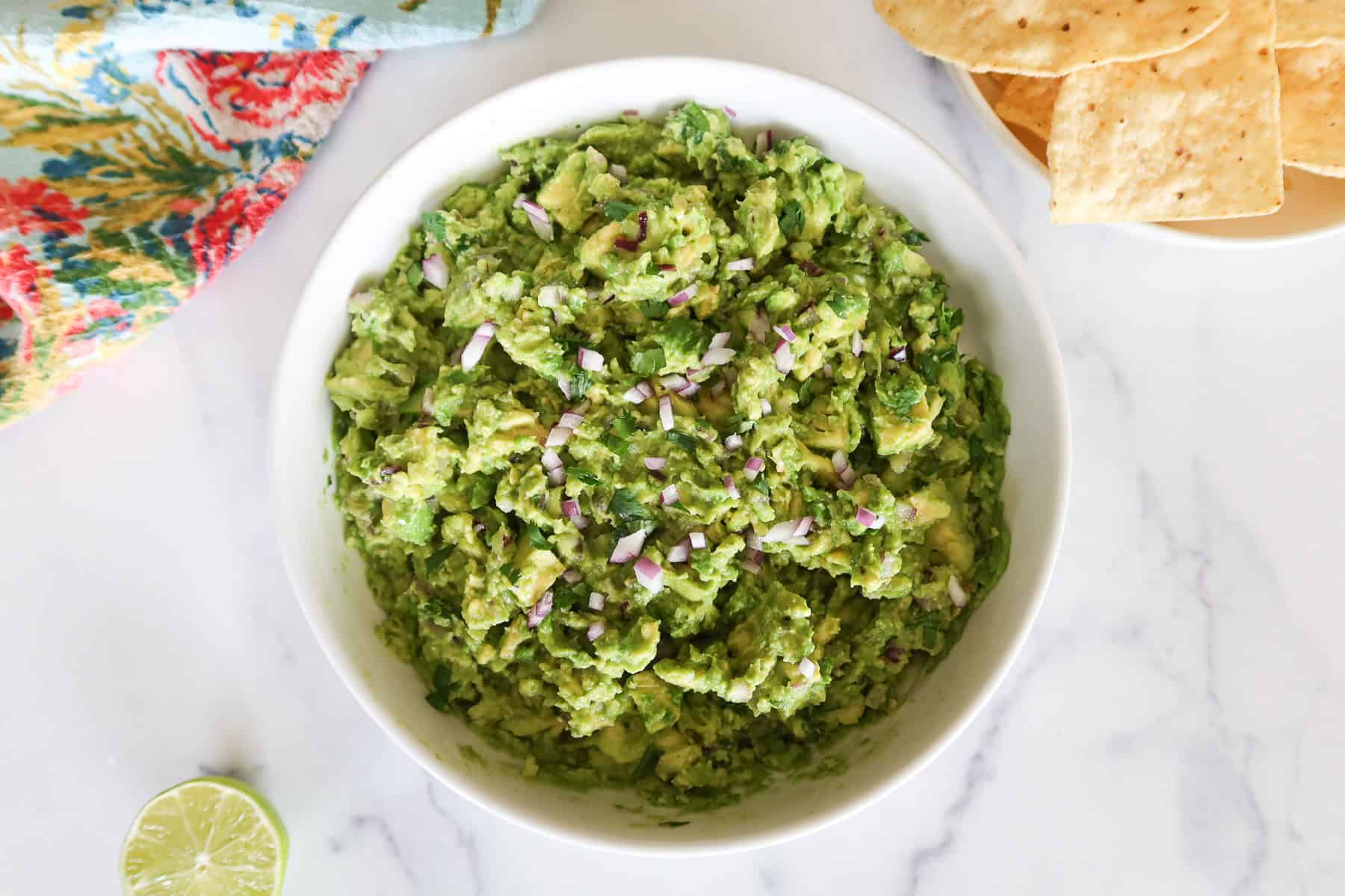 Guacamole in a white serving dish.