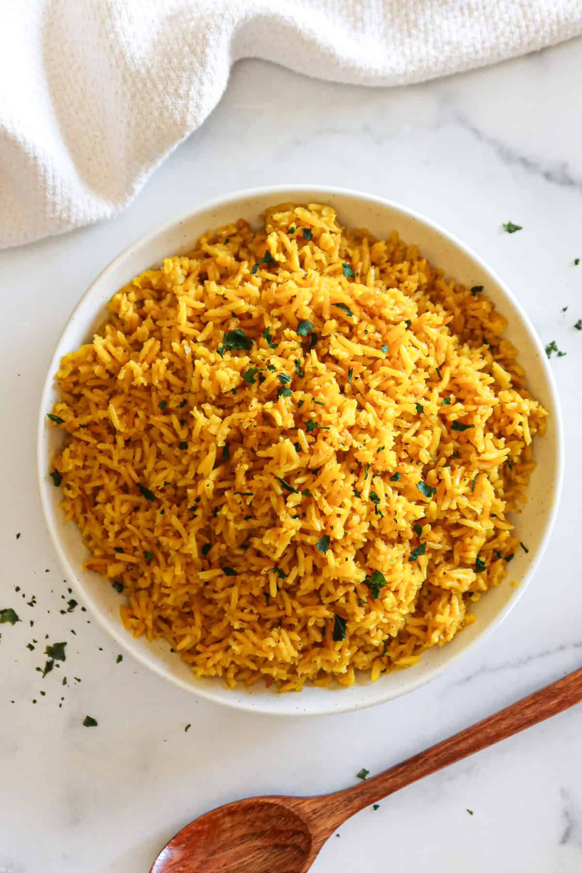 Yellow rice in a white serving dish.