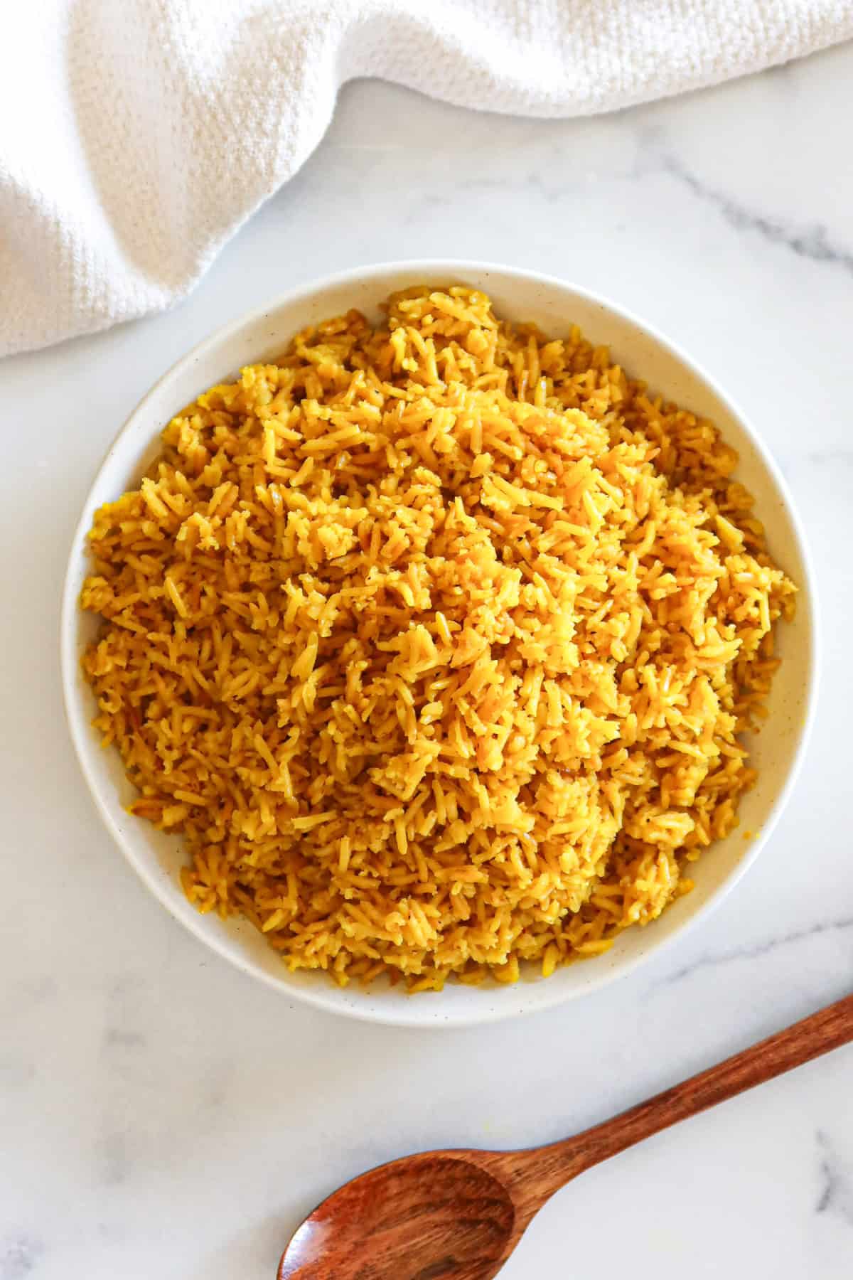 Yellow rice in a white serving dish.