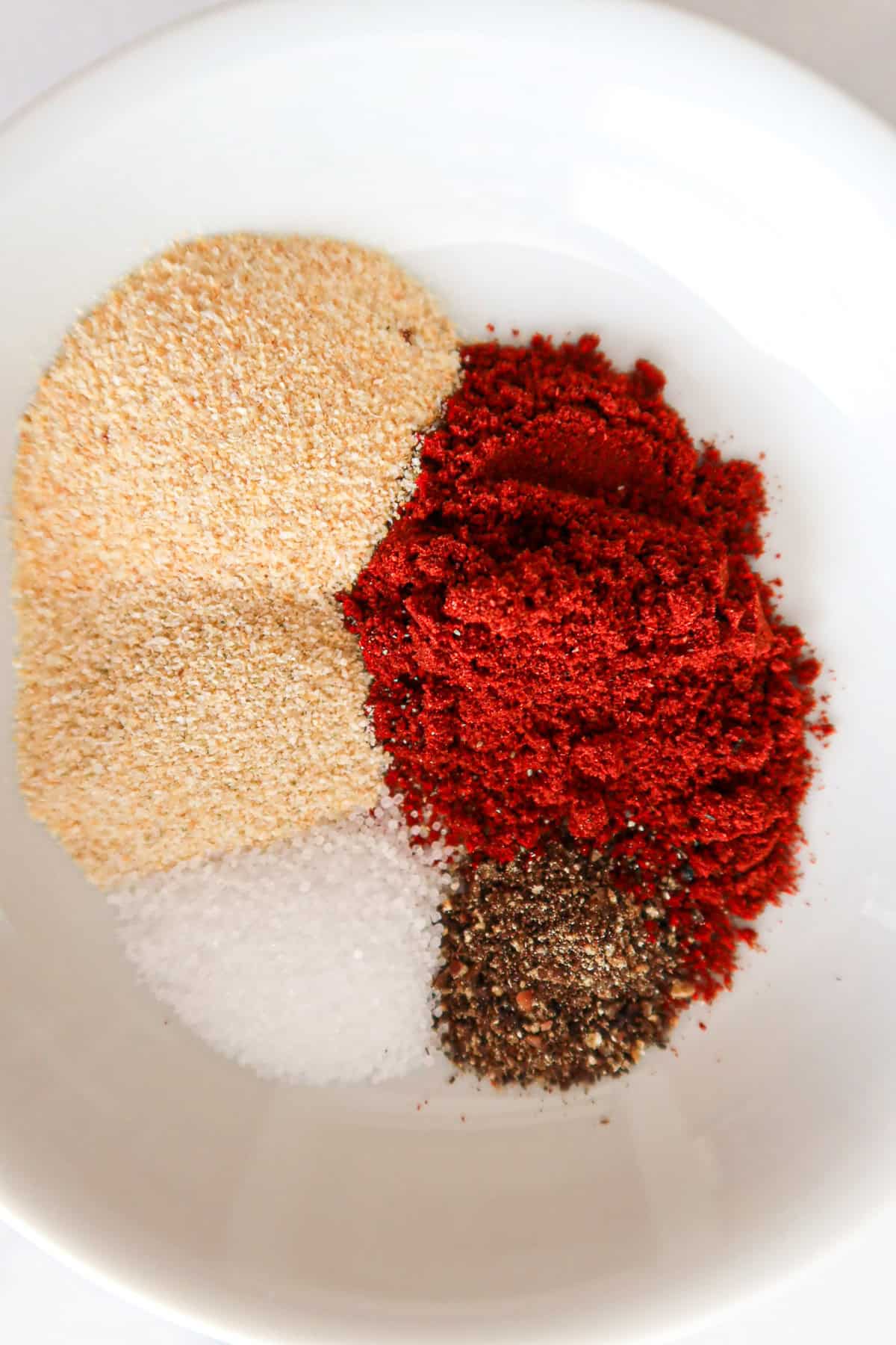 Seasonings for burgers measured into a small bowl.