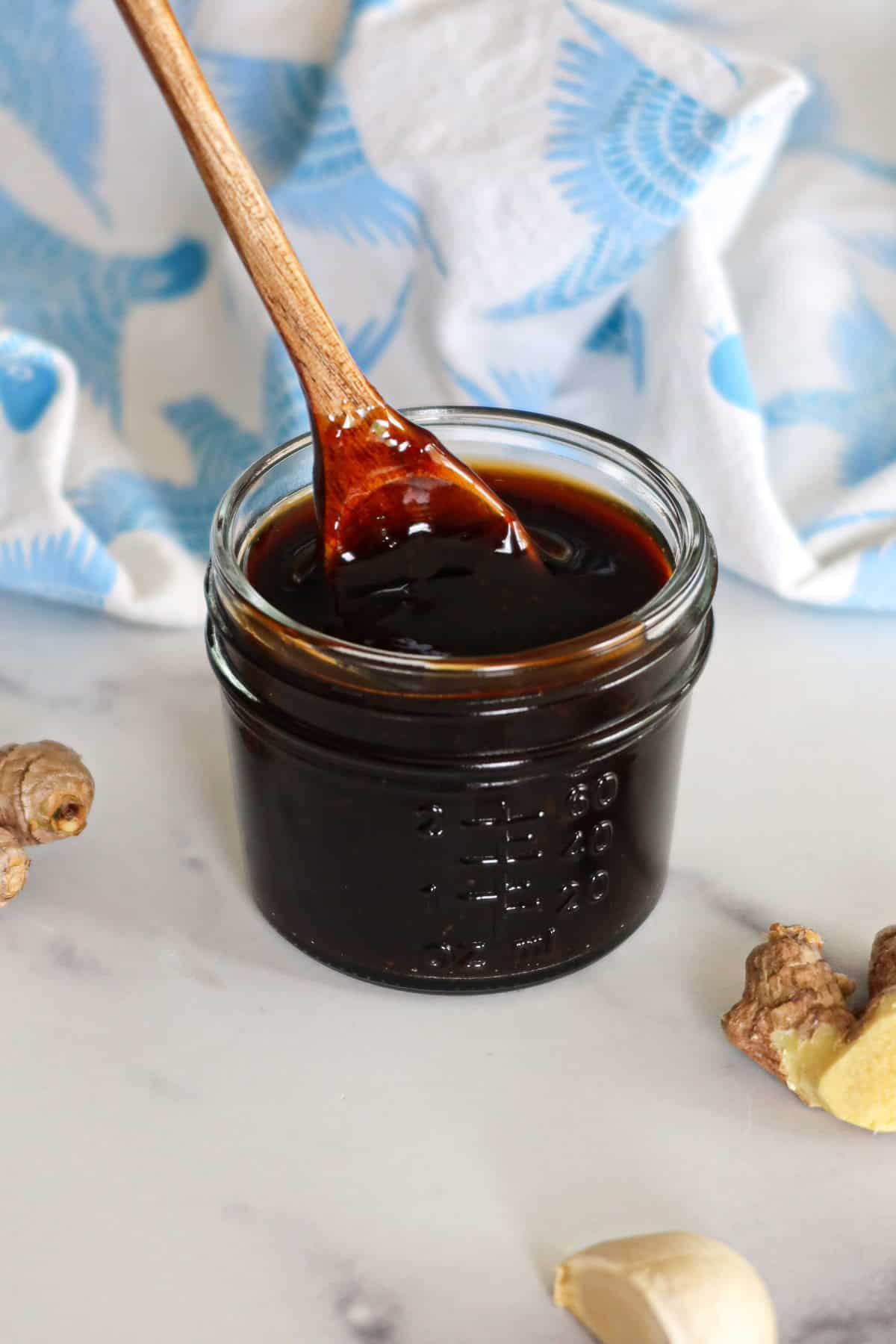 Homemade teriyaki sauce in a glass jar.