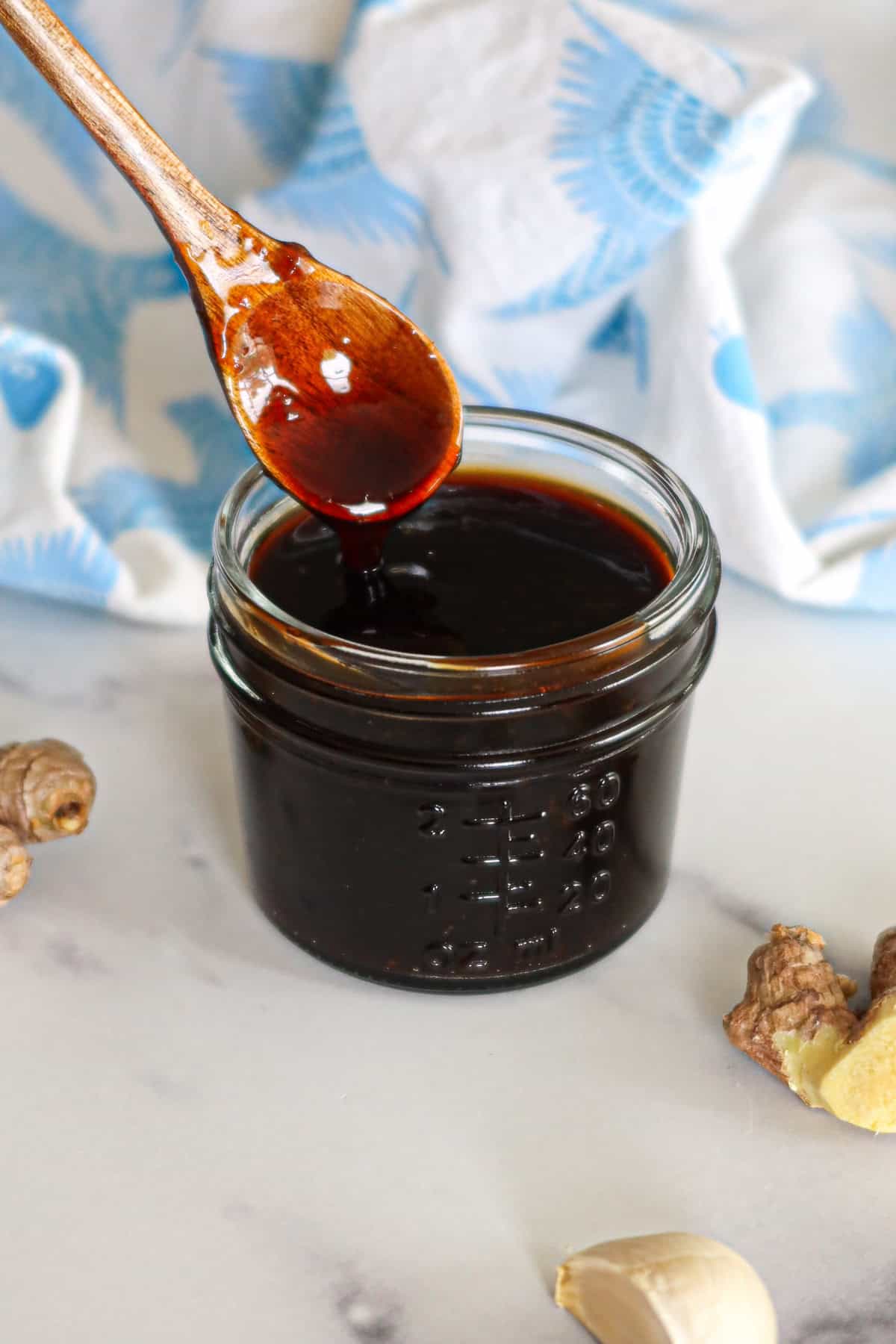 Homemade teriyaki sauce in a glass jar.