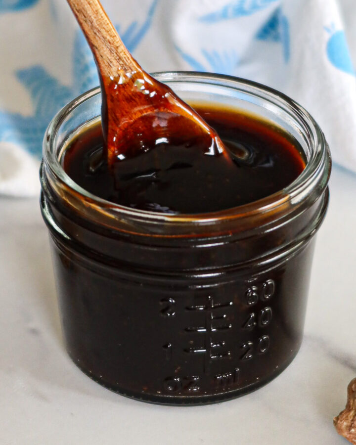 Homemade teriyaki sauce in a glass jar.