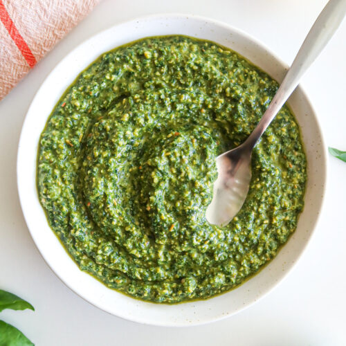A white bowl full of dairy free pesto.