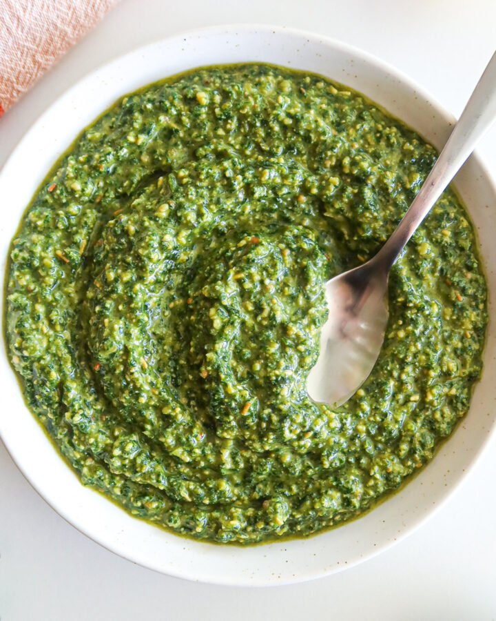 A white bowl full of dairy free pesto.