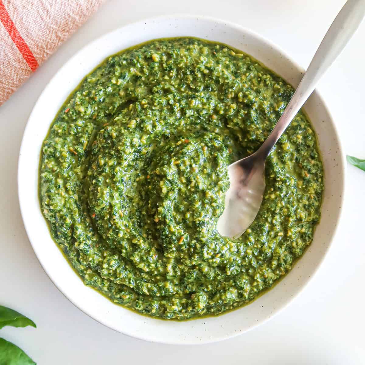 A white bowl full of dairy free pesto.