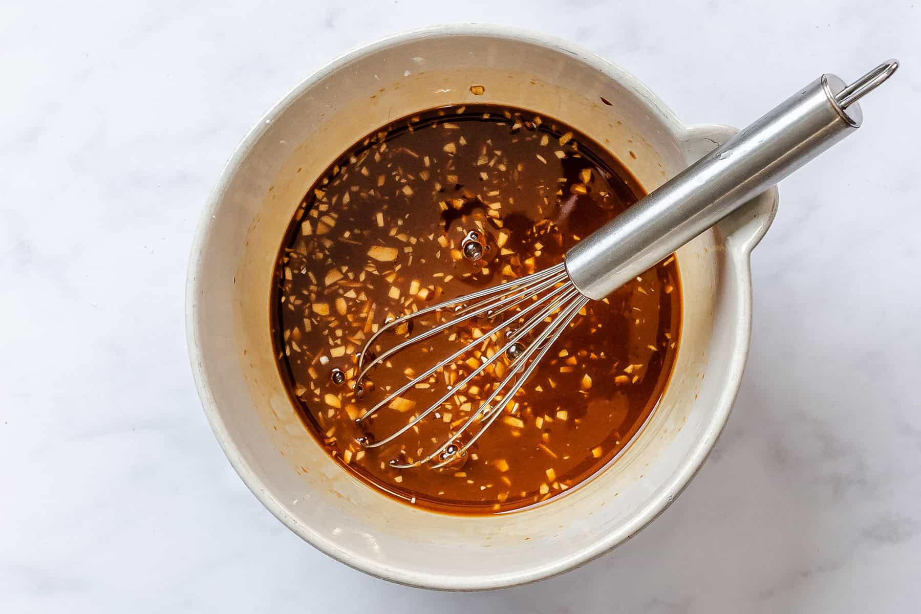 Teriyaki sauce ingredients whisked together in a bowl.